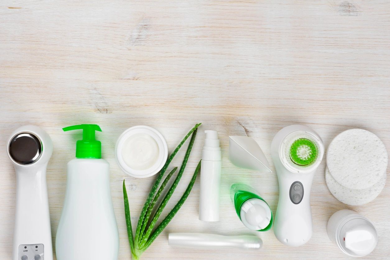 A white table topped with lots of green items.