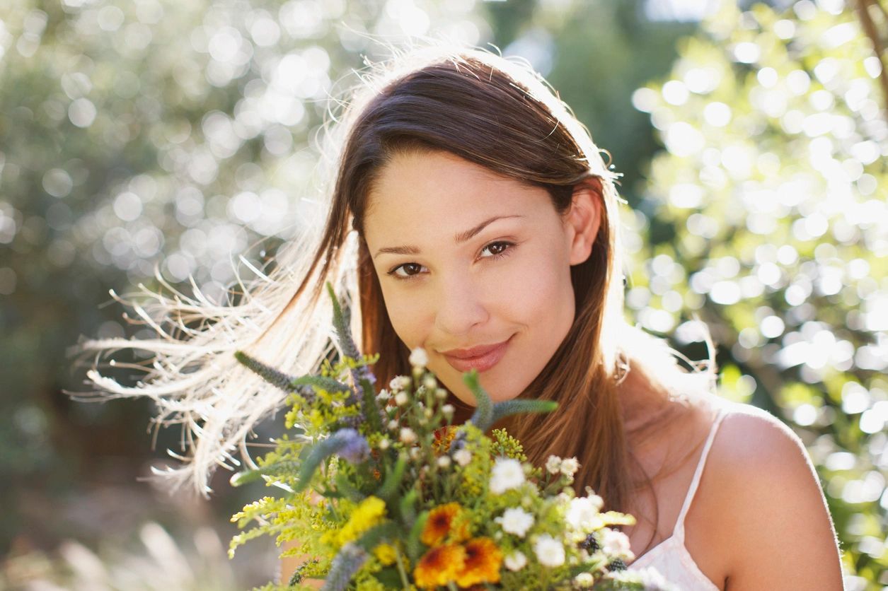 A woman holding flowers in her hands.