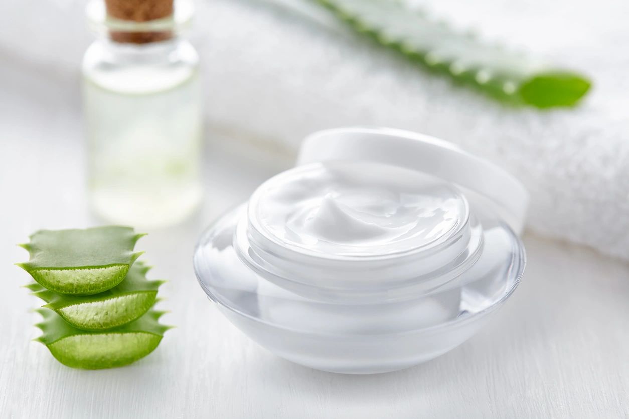 A close up of an open jar with cream on it