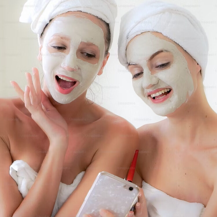 Two women with facial masks taking selfie.